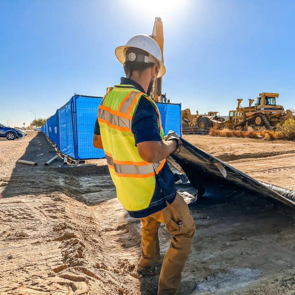 Worker on desert pipeline