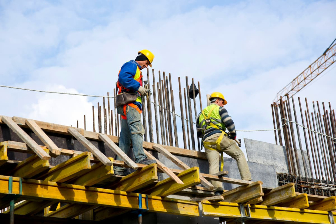 Construction crew working in direct summer heat, a setting covered by OSHA heat inspections